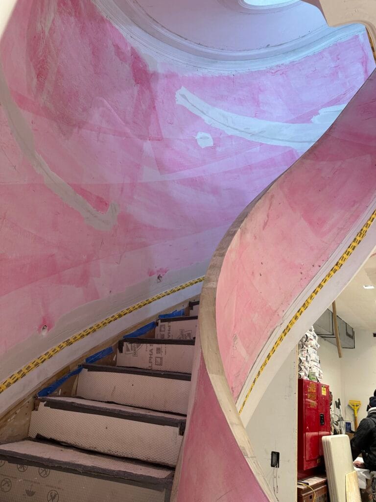 Drywall installation and finishing around a staircase
