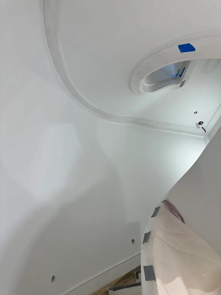 Drywall installation and finishing around a staircase